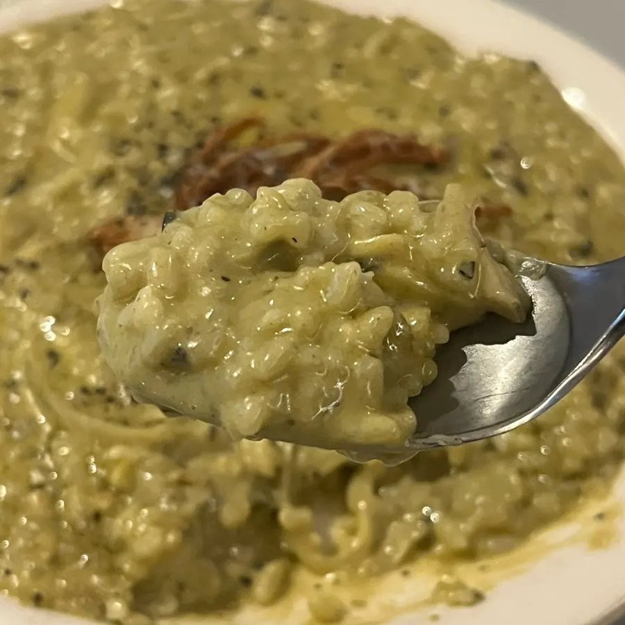 Finely chopped abalone and mushroom visible inside the risotto