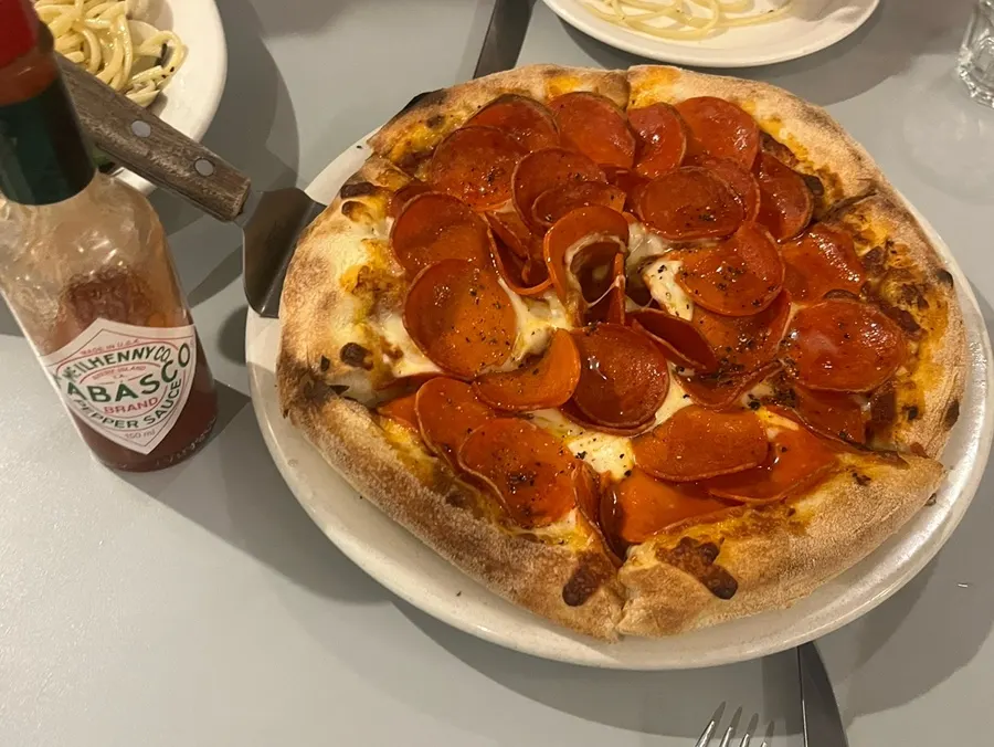 Pepperoni pizza cut into six slices