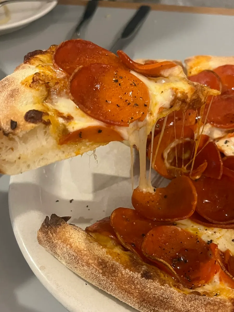 Pizza piled generously with pepperoni