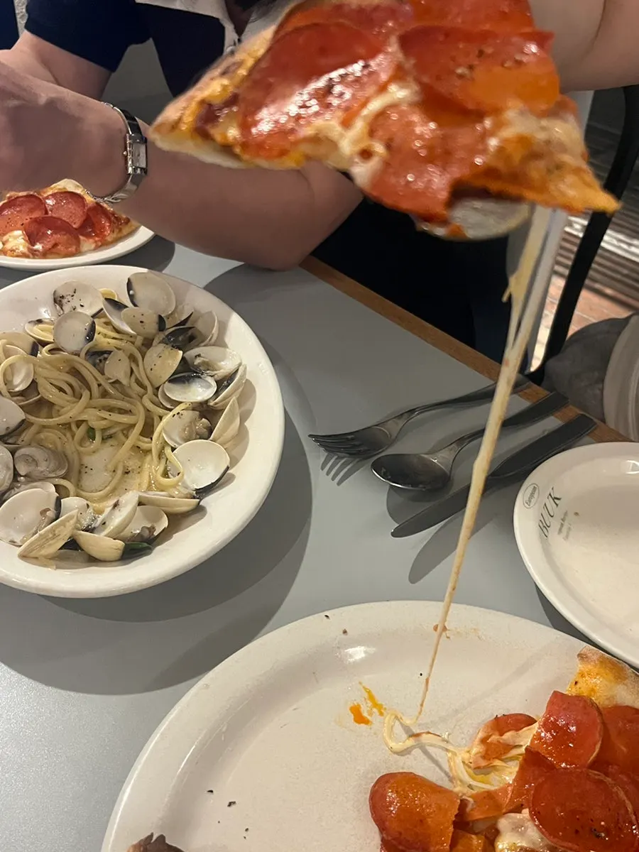A slice of pepperoni pizza with stretchy cheese