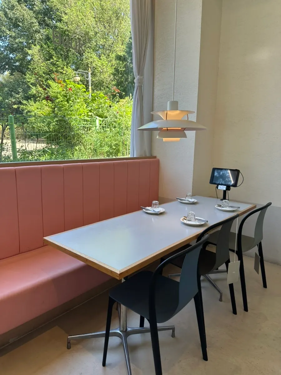 Table with a view of the green scenery outside the window