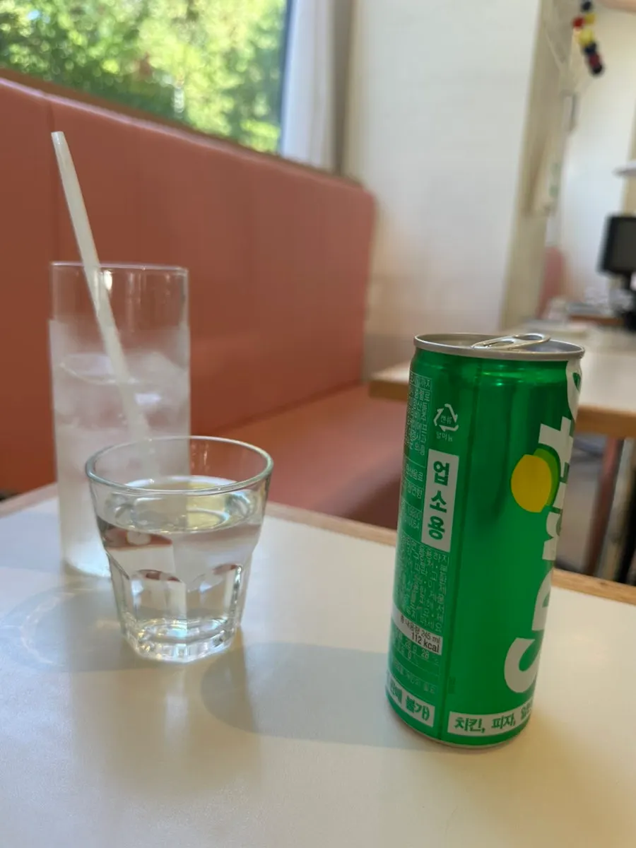Basic side dishes of cucumber and radish pickles with iced soda drinks