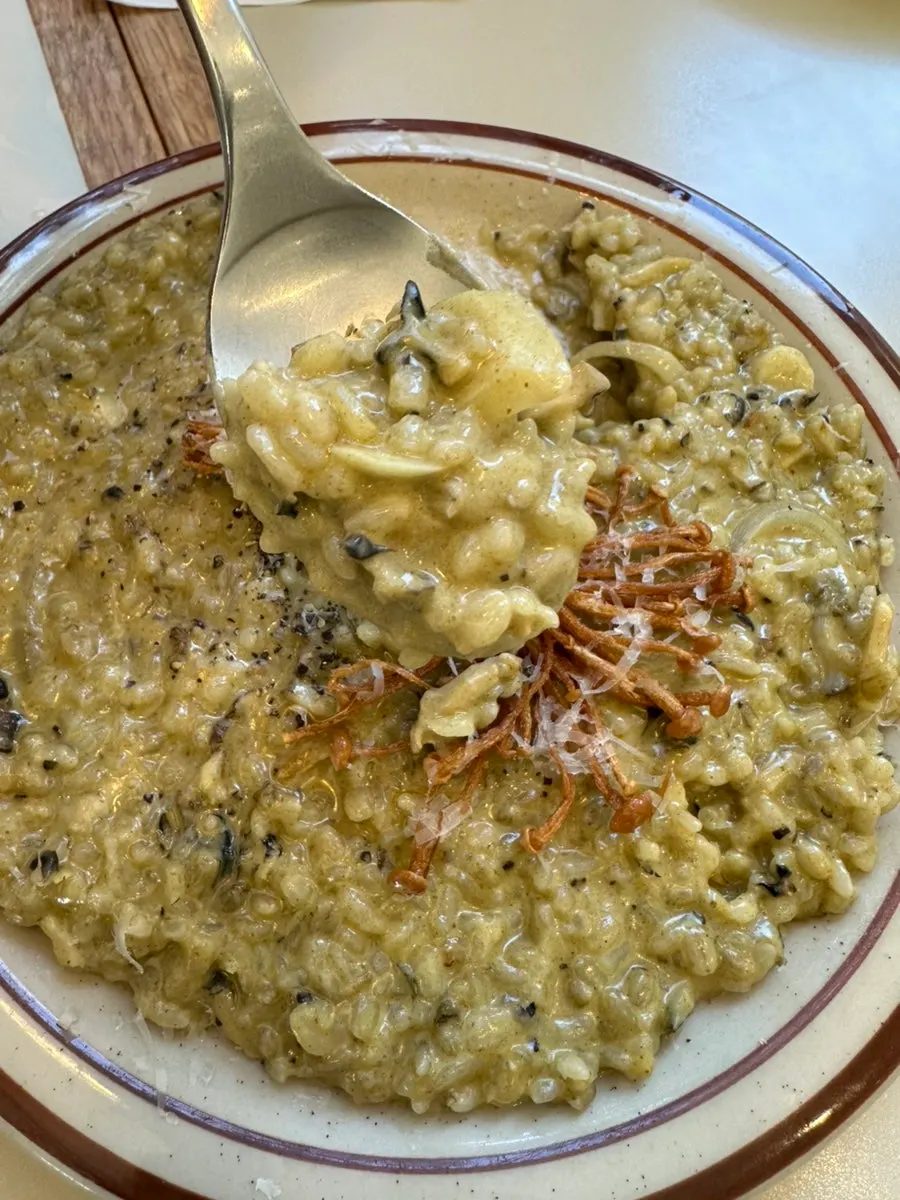 Abalone cream risotto topped with fried enoki mushrooms