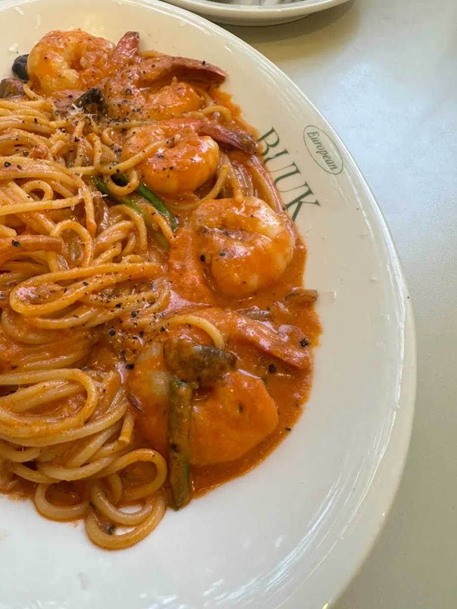 Close-up of pasta noodles coated in rose sauce