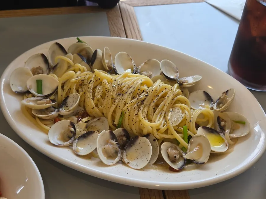 Lifting a forkful of oil pasta noodles