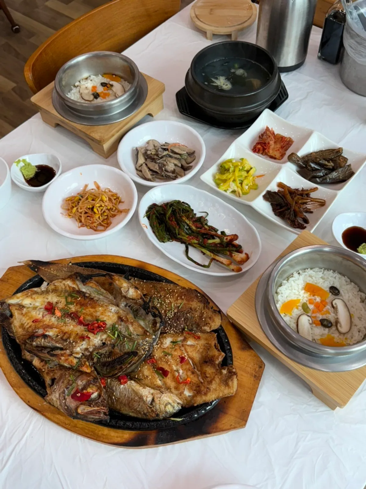 Full table set with clay-pot rice and grilled fish set