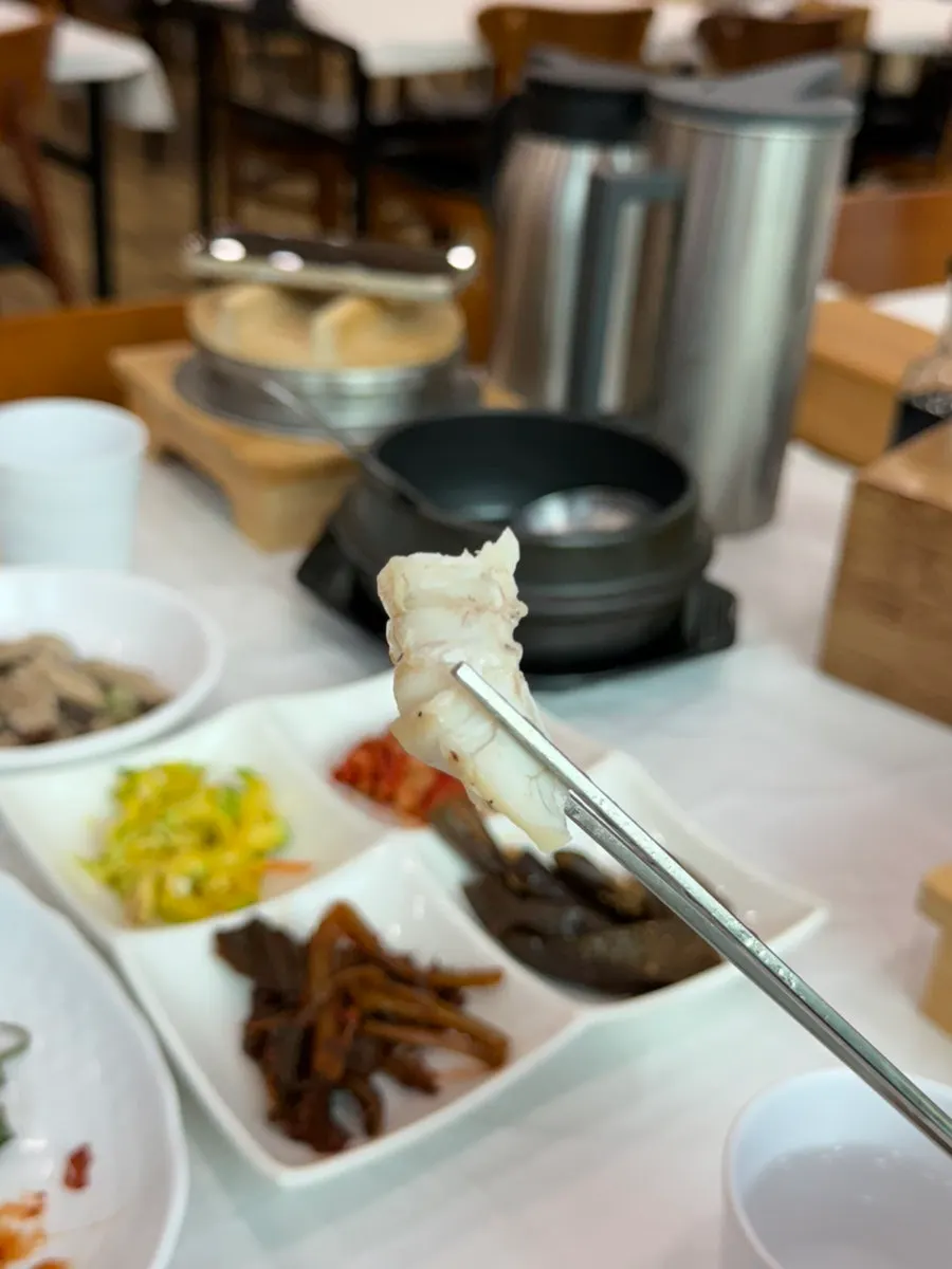 A bite of grilled fish eaten with clay-pot rice