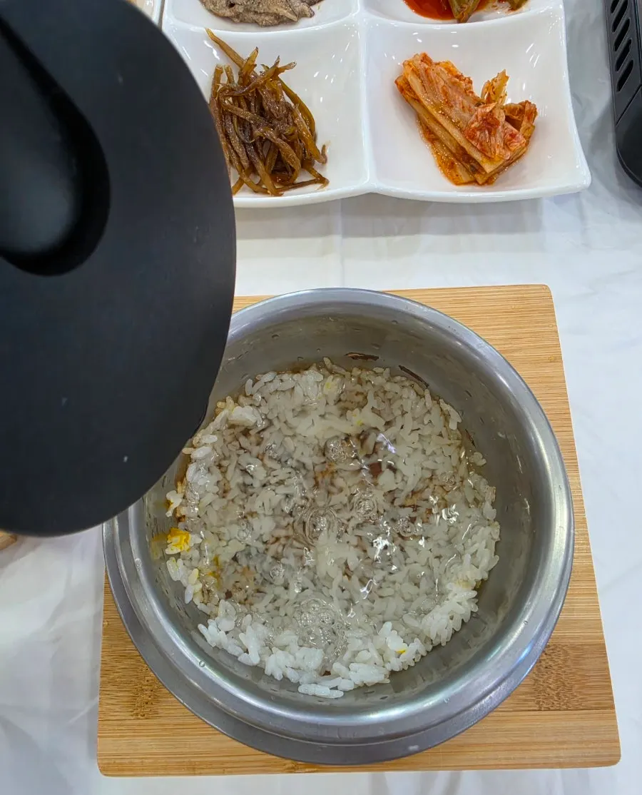 Inside the hotpot rice topped with carrots, shiitake, and sweet pumpkin