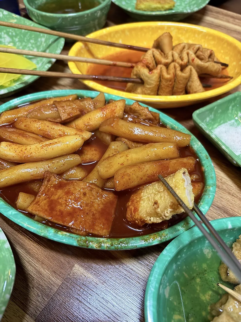 Fried snack dipped into tteokbokki sauce