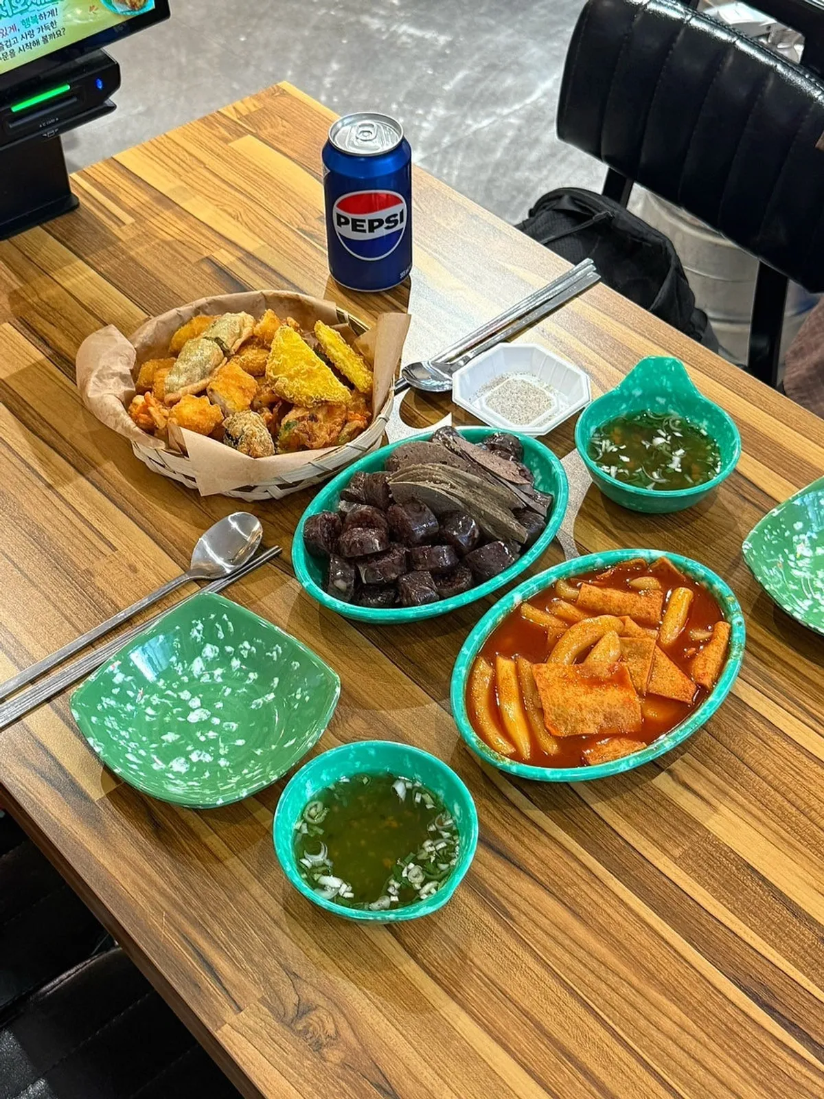 Table set with tteokbokki, fritters, and sundae