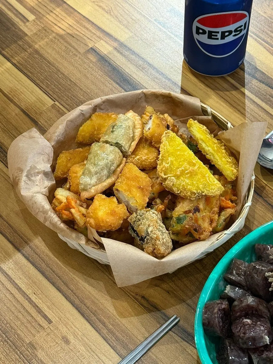 Plate of squid fritters, vegetable fritters, and free fritters