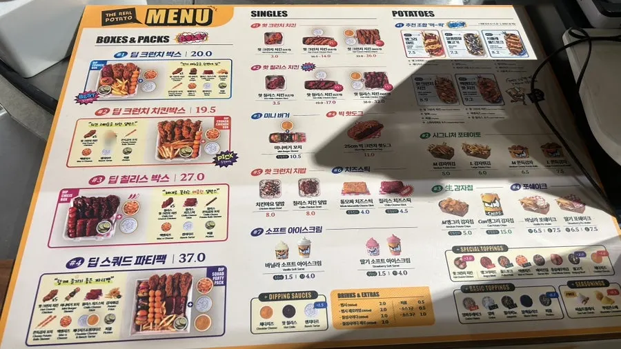 Ordered menu items laid out on the table at Angry Potato