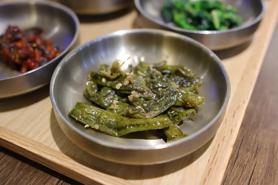 Braised shishito peppers with anchovies and seasoned bellflower root