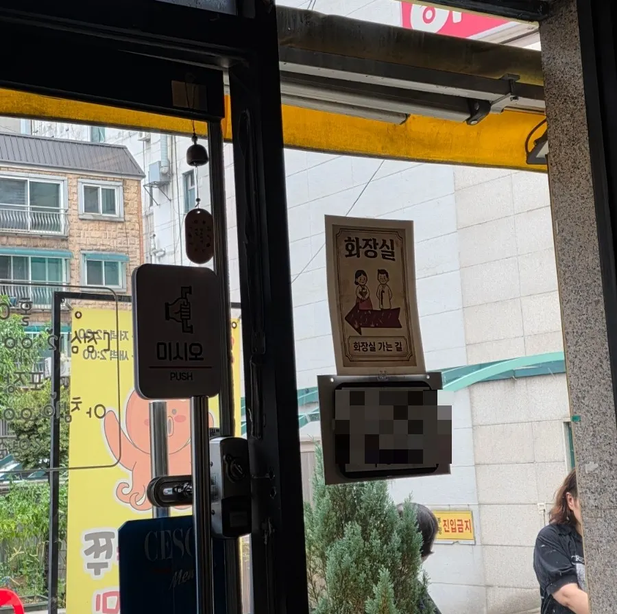 Corner of the restaurant with sign for outside restroom