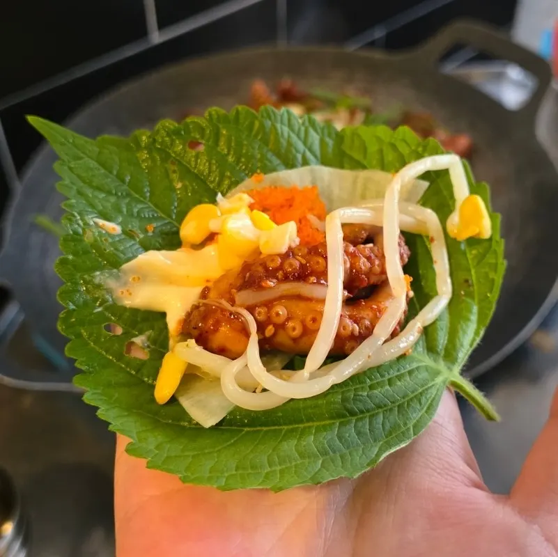 Perilla leaf wrap with jjukkumi, flying fish roe, and corn