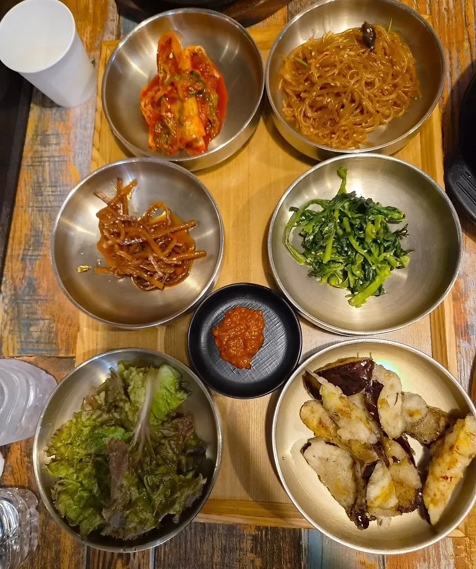 Korean set meal side dishes with seasoned vegetables and kimchi