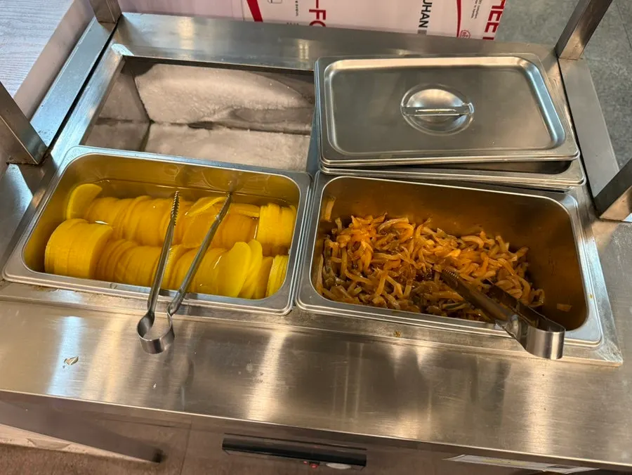 Self-service bar with side dishes and rice cooker