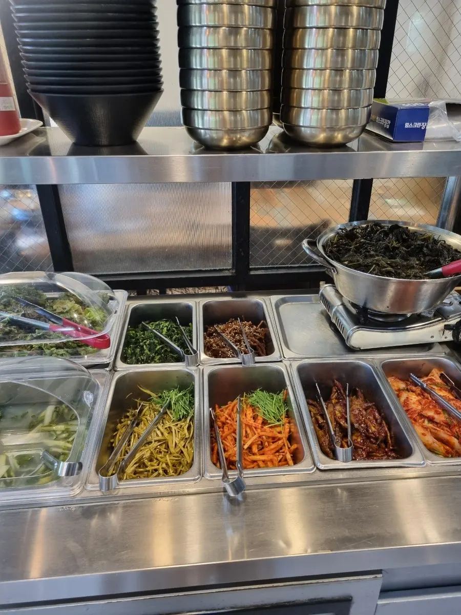 A variety of banchan laid out at the self-bar