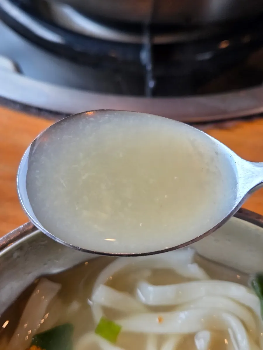Kalguksu noodles cooking in broth
