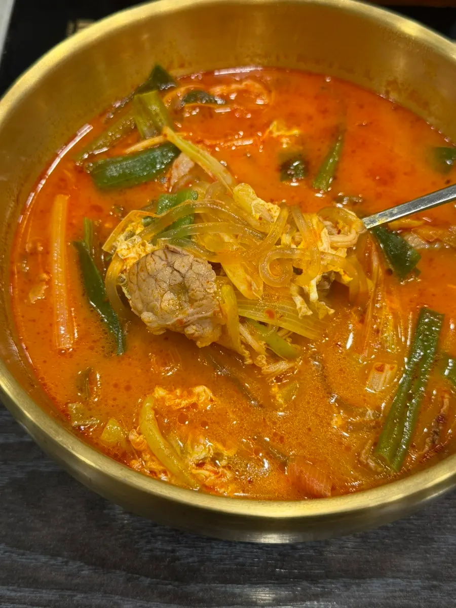 Inside the spicy seolleongtang with vegetables, egg, meat, and glass noodles