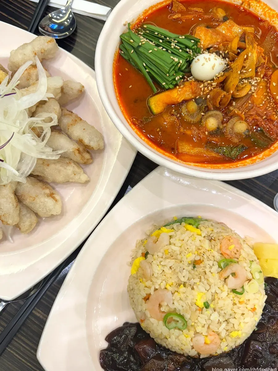 Table spread with jjamppong, sticky rice tangsuyuk, and shrimp fried rice
