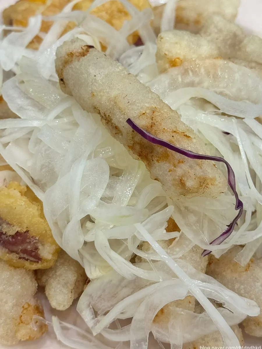 Sticky rice tangsuyuk topped with raw onion and sweet potato fritters