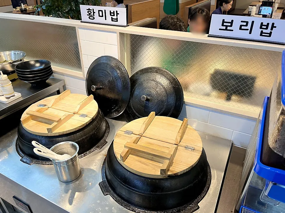 Yellow rice and barley rice in cauldrons