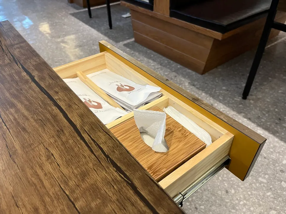 Table drawer with spoons and wet wipes