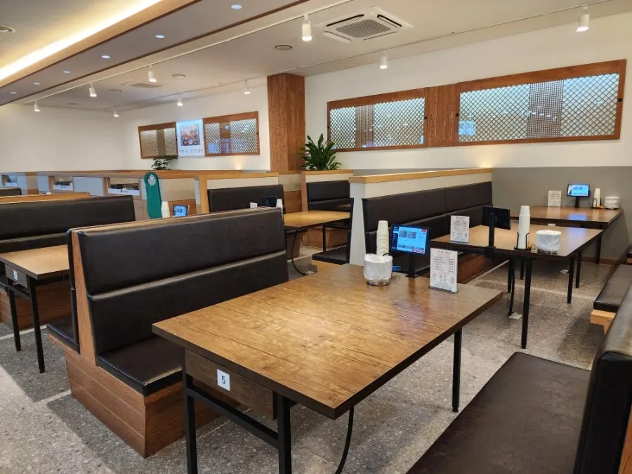 Window seats and group seating inside the restaurant