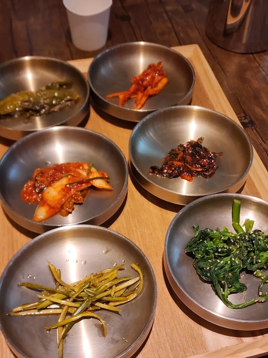 Plates of namul and other side dishes on the table