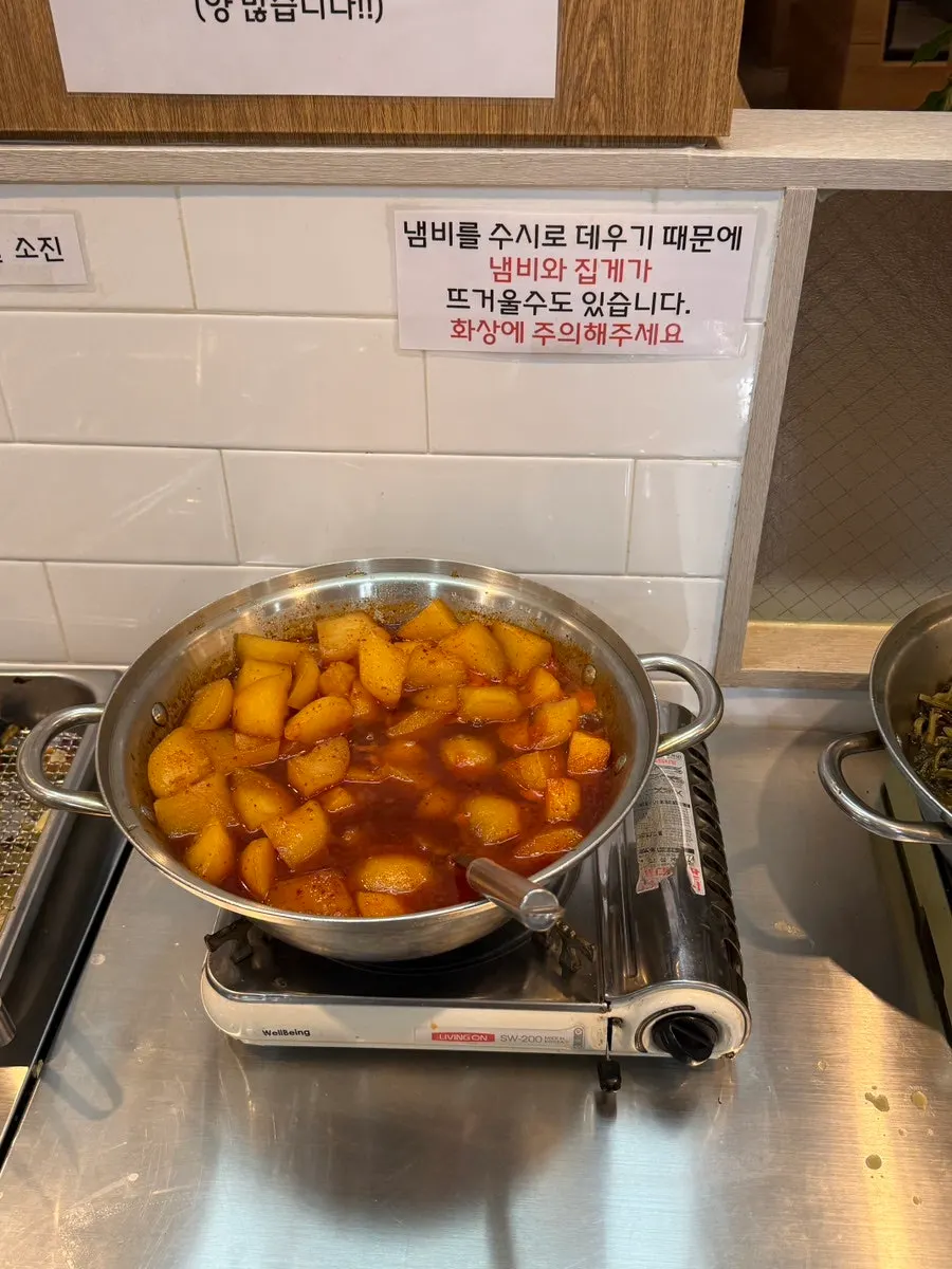 Yellow rice and barley rice in a cast-iron cauldron