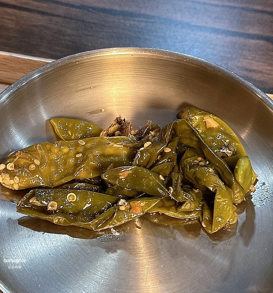 A plate of pickled side dishes that were refilled during the meal