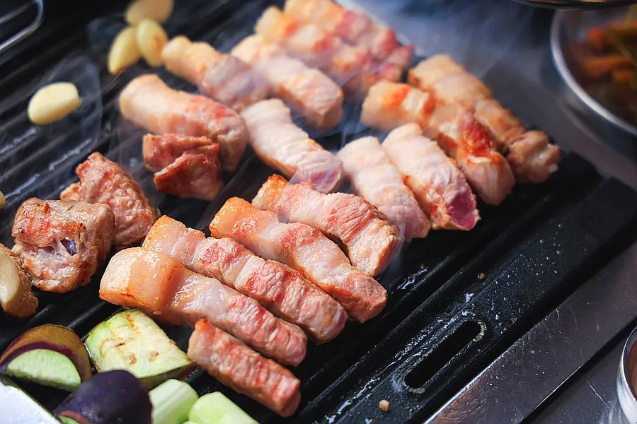 Thick meat cooking to a golden brown