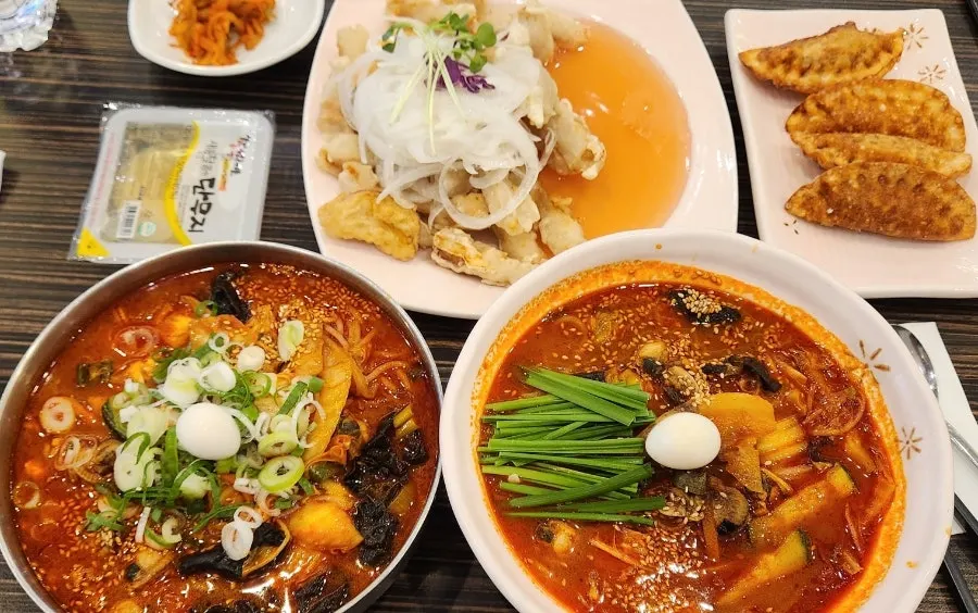 Full spread of soft tofu jjamppong, seafood jjamppong, tangsuyuk, and jjamppong dumplings