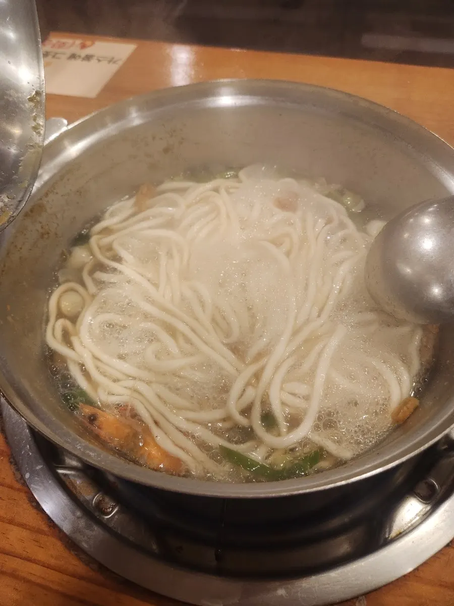 Kalguksu cooking in a pot