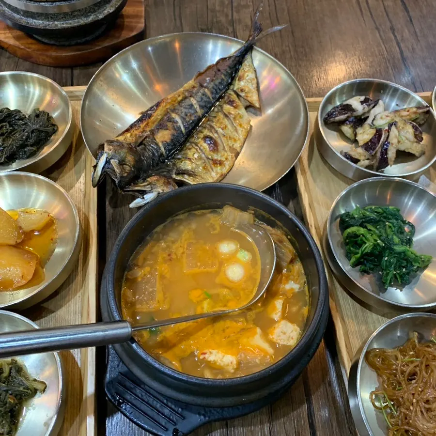 Side dishes including spinach, kimchi, and japchae