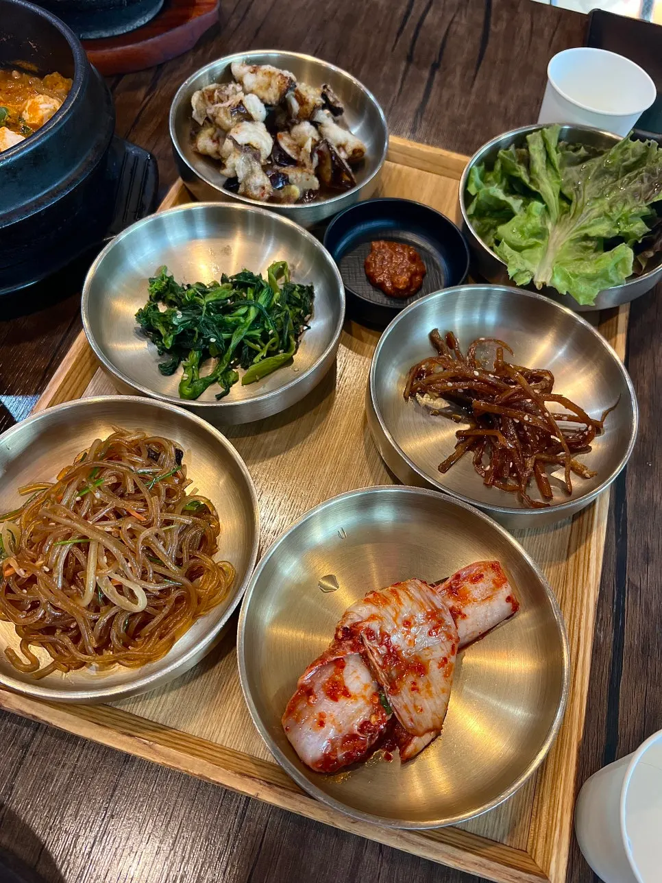 Tteuranchae Bapsang side dishes including japchae, kimchi, and fried eggplant