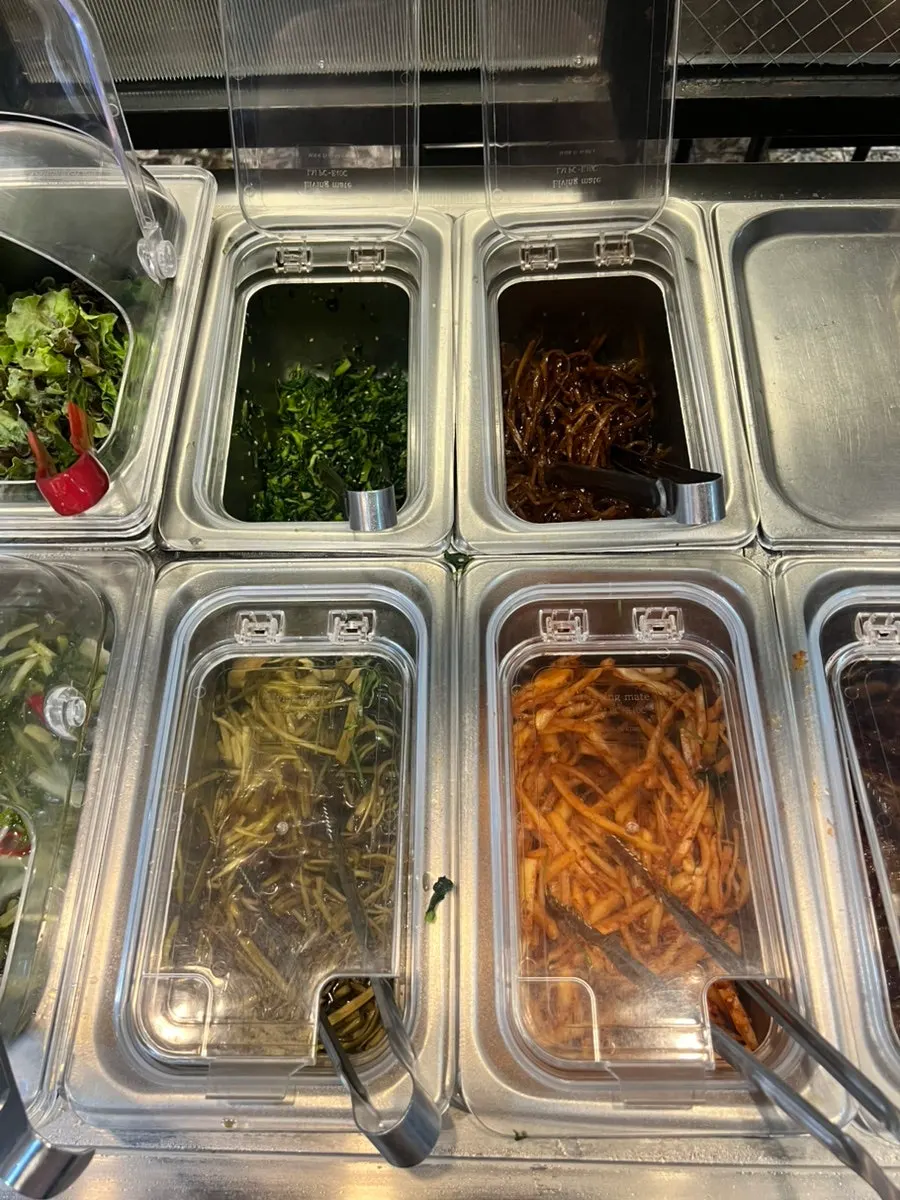 Self-bar banchan including braised potatoes and fried eggplant