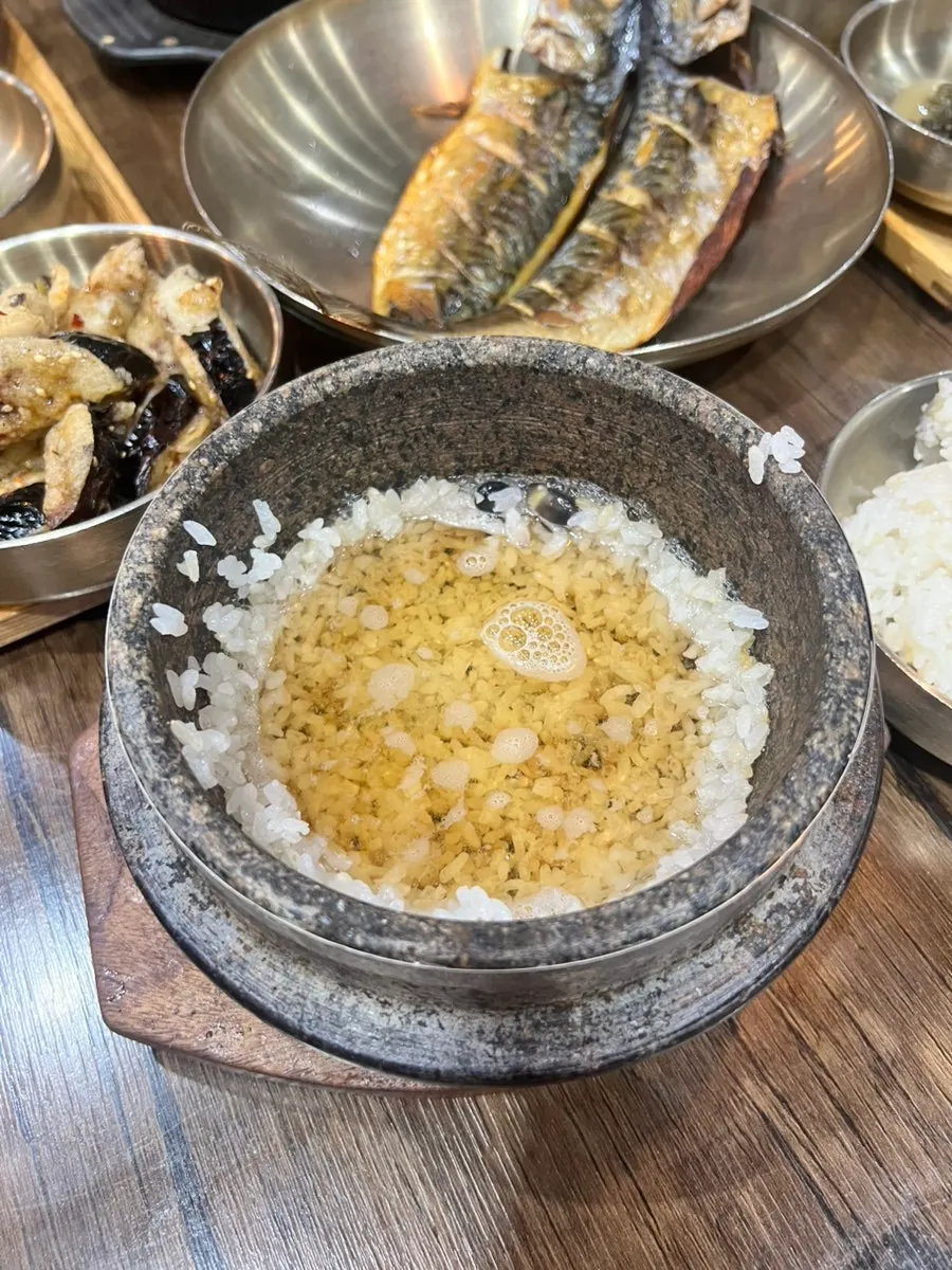 Table for two laid out with the basic Korean set-meal banchan