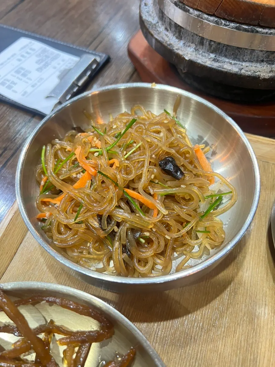 A spoonful of rice topped with kimchi