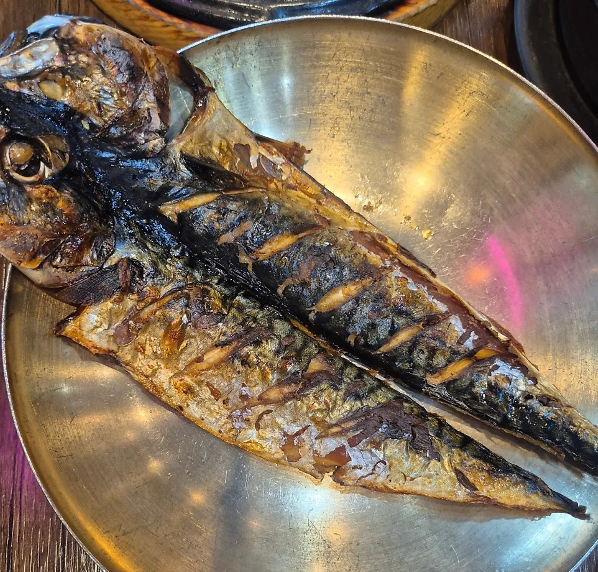 Table with grilled mackerel and charcoal-grilled pork added