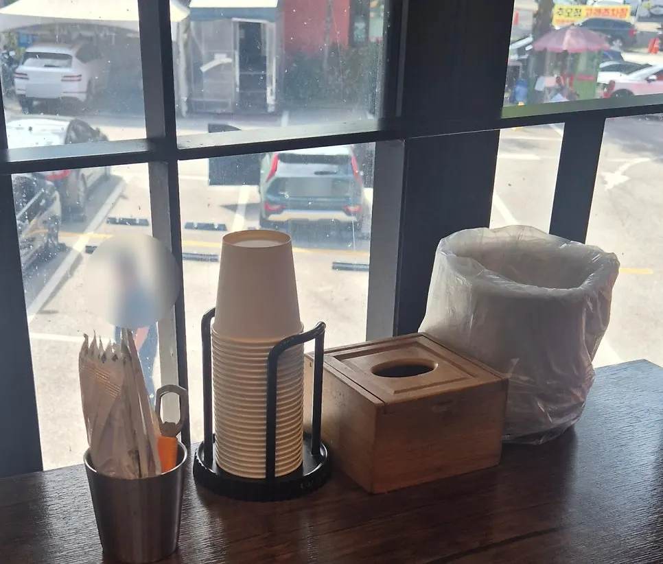 Table set with paper cups, wet wipes, and a bottle opener