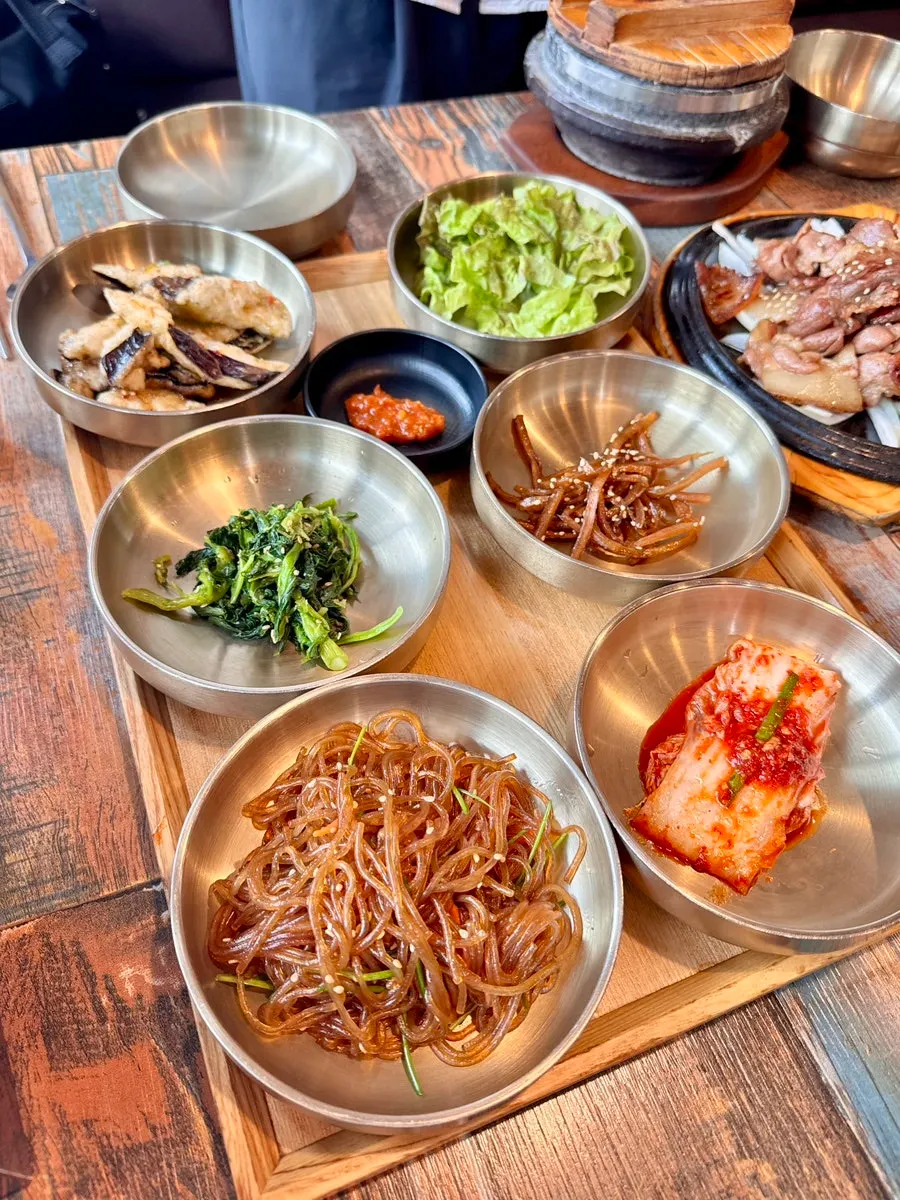 Plates of namul and japchae among the standard banchan