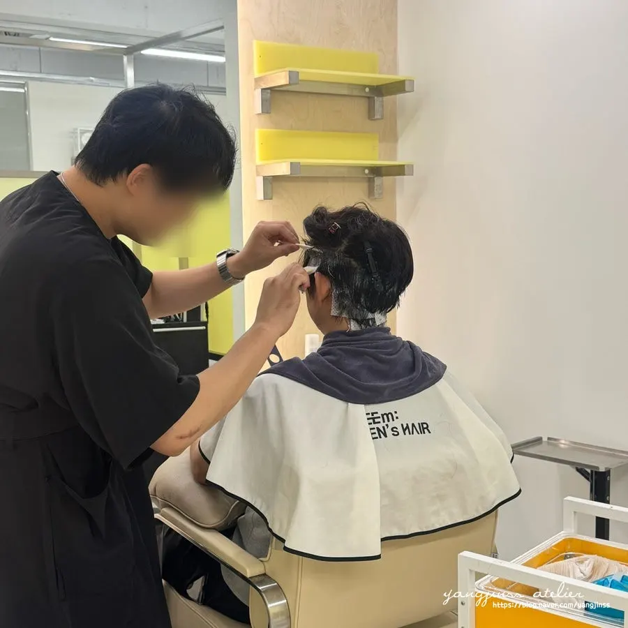 Down perm being applied to the side and back hair