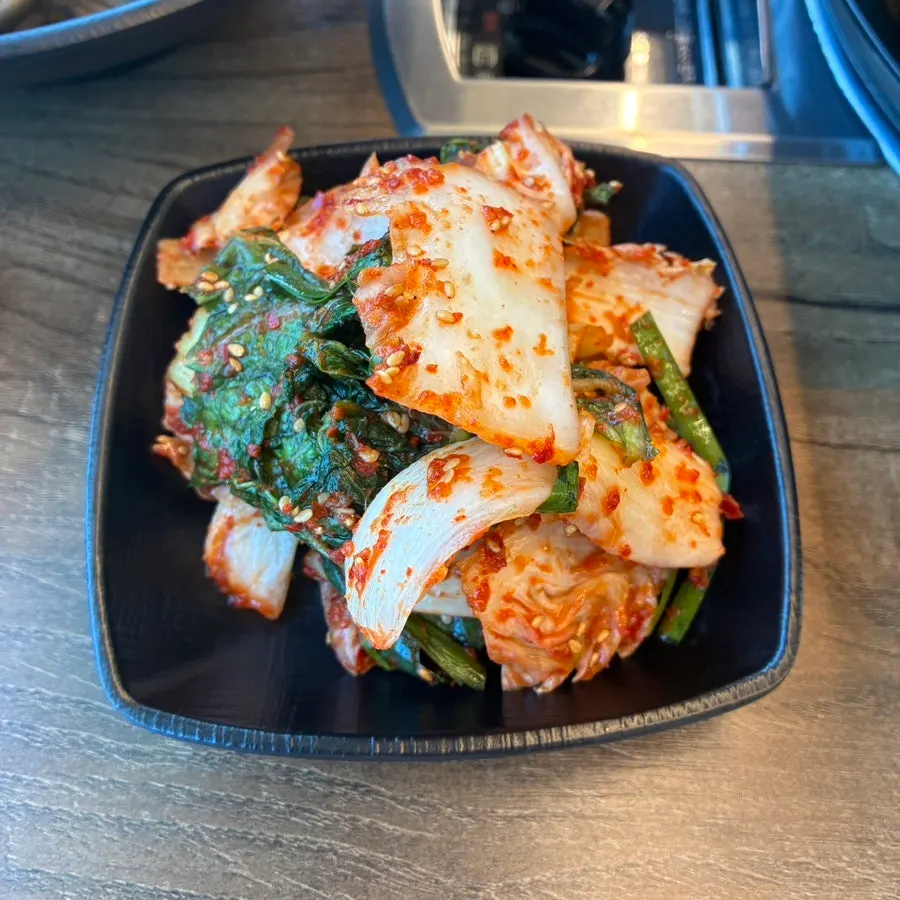 A bowl of gondre mushroom rice with fresh kimchi