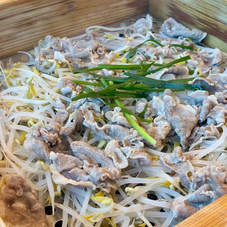 Steaming hot cedar-box duck with the lid just opened
