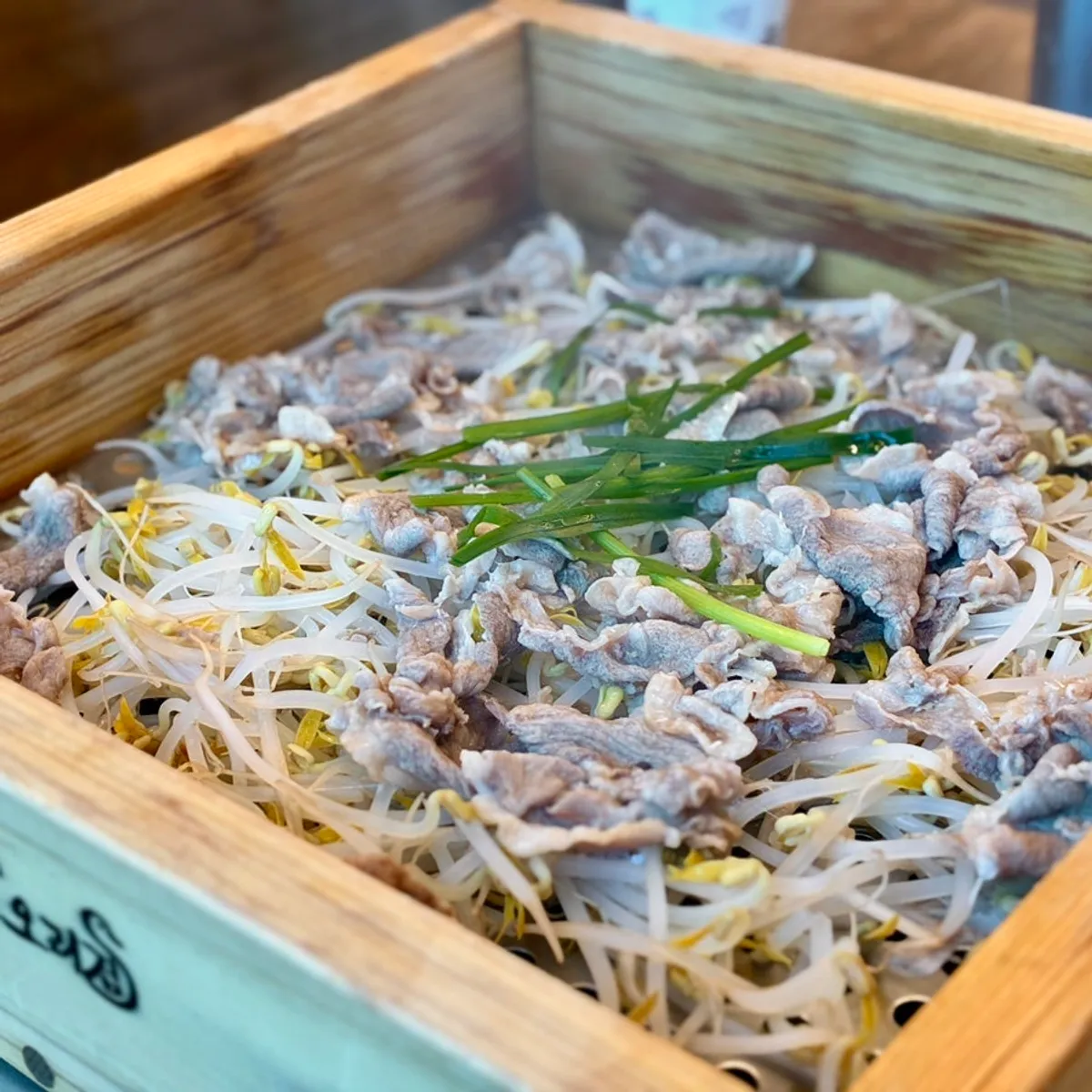 Cedar-steamed duck piled high with bean sprouts and duck meat