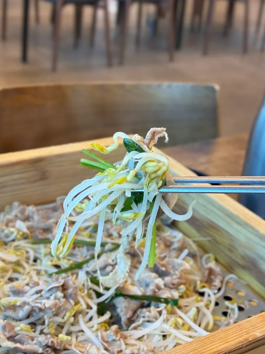 A tender piece of duck meat from the cedar steam