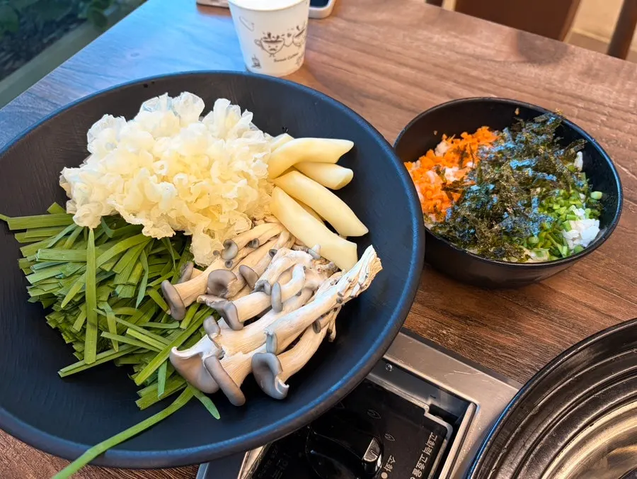 Plate of vegetable and rice cake add-ons