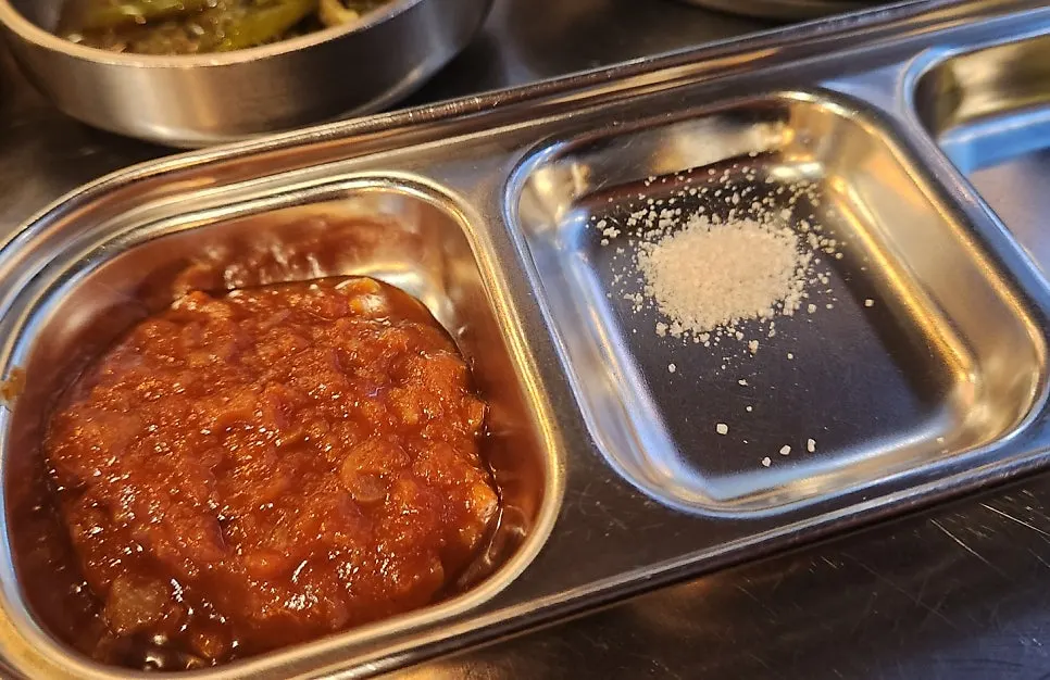 A piece of meat placed on a lettuce wrap